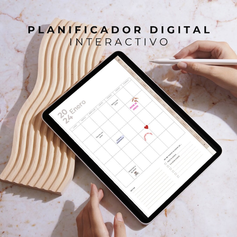 May include: A white digital planner app on a tablet with the text "PLANIFICADOR DIGITAL INTERACTIVO" at the top. The planner is open to January 20, with a calendar view and a to-do list. The tablet is on a wooden surface.
