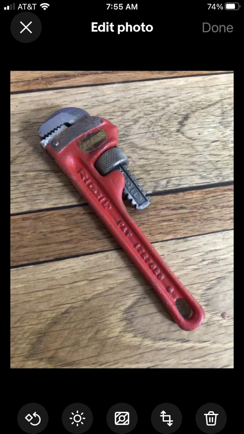 May include: A red pipe wrench with a silver handle and the text "RIDGID 14" printed on the handle.