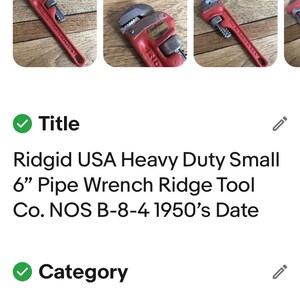 May include: A red Ridgid USA Heavy Duty Small 6" Pipe Wrench Ridge Tool Co. NOS B-8-4 1950's Date. The wrench is on a wooden surface.