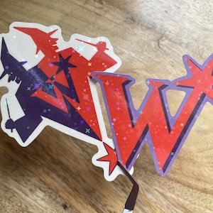 May include: Two stickers, one featuring a purple wizard holding a wand and the other a red letter W with a star. Both stickers have a glittery background.