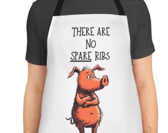 May include: White apron with black straps featuring the text "THERE ARE NO SPARE RIBS" above a cartoon pig with crossed arms. The pig is orange with a large snout and small ears. The apron is worn by a person.