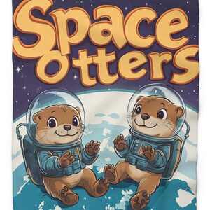 May include: A plush blanket featuring two cartoon otters in space suits, floating above a blue and white planet. The blanket has the words "Space Otters" in large, yellow, retro-style lettering against a dark blue starry background.
