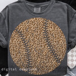 May include: A dark gray sweatshirt featuring a large baseball design with a leopard print pattern. The baseball has dark gray stitching details. The words "digital download" are printed at the bottom left, and "DESIGNED BY RIPPENT" is printed at the bottom right.
