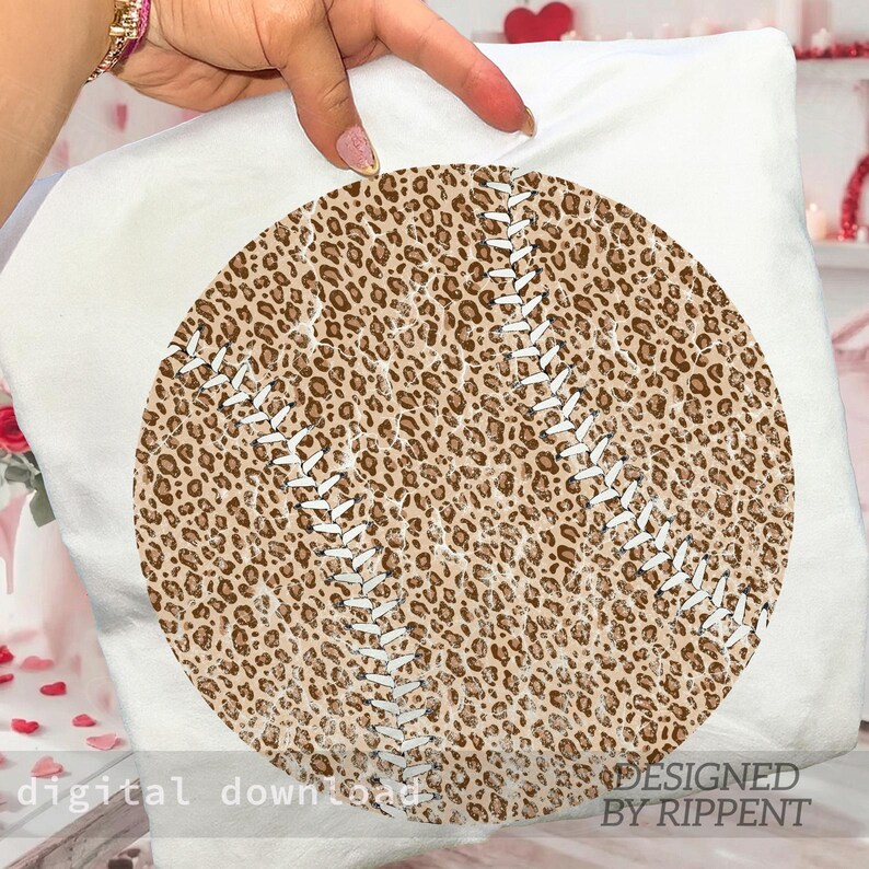 May include: A baseball-themed pillow with a leopard print design. The baseball has white stitching and a brown and tan spotted pattern. The words "digital download" and "designed by Rippent" are visible.