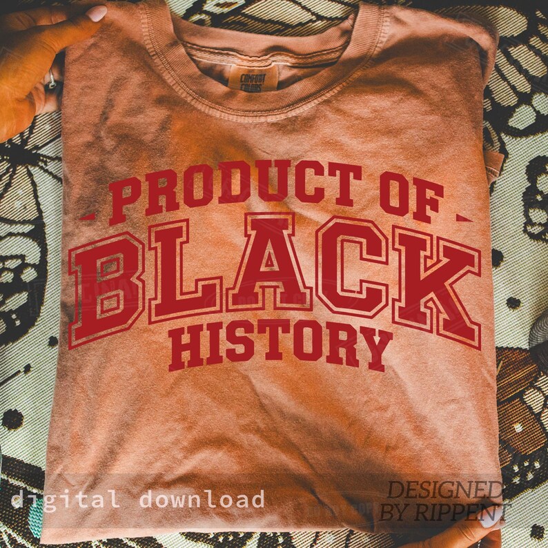 May include: A peach-colored t-shirt with the words "PRODUCT OF BLACK HISTORY" in red, collegiate-style lettering. The shirt is folded and held by hands. The words "digital download" and "DESIGNED BY RIPPENT" are also visible.