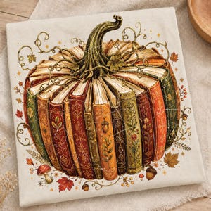 May include: A cream-colored fabric featuring a graphic illustration of a pumpkin constructed from vertically arranged vintage books. The books display ornate gold-toned floral patterns in shades of orange, green, and brown, topped with a green stem.