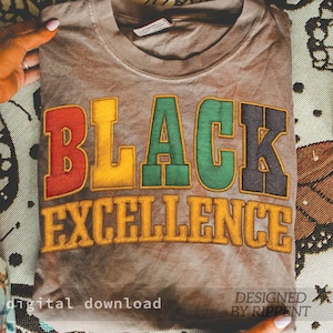 May include: A folded brown t-shirt with the words "BLACK EXCELLENCE" in colorful, embroidered lettering. The text is in red, yellow, green, and black. The words "digital download" and "designed by Rippent" are also visible.