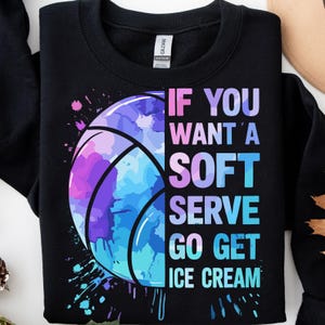 May include: Black sweatshirt with a colorful basketball graphic. The basketball is a mix of purple, blue, and pink watercolor-style paint. Text on the right side reads "IF YOU WANT A SOFT SERVE GO GET ICE CREAM."