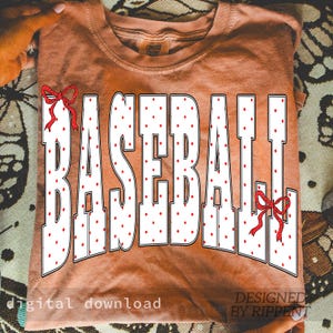 May include: A terracotta-colored t-shirt with the word "BASEBALL" in large white letters filled with red polka dots. Red bows accent the top and bottom of the word. The words "digital download" and "DESIGNED BY RIPPENT" are printed at the bottom.