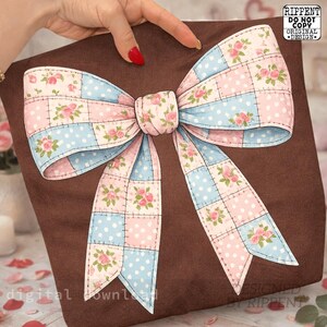 May include: A brown fabric bag with a large, decorative bow. The bow is made of patchwork squares in pink and blue, with white polka dots and floral accents. The bow is the focal point of the design.