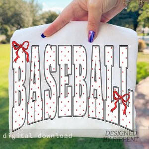 May include: White fabric with the word "BASEBALL" in large, bold letters. The letters are white with red polka dots and outlined in black. Red bows accent the design. The words "digital download" and "DESIGNED BY RIPPENT" are also visible.