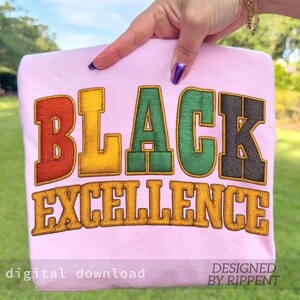 May include: A light pink sweatshirt with the words "BLACK EXCELLENCE" in a colorful, textured font. The text is in red, yellow, green, and black. The words "digital download" and "DESIGNED BY RIPPENT" are also visible.