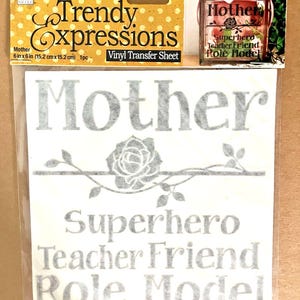 May include: A vinyl transfer sheet with the words "Mother", "Superhero", "Teacher Friend", and "Role Model" in a gray font. The sheet is 6 inches by 6 inches (15.2 cm x 15.2 cm). The words are arranged with a floral design.