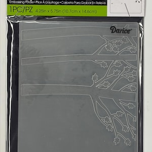 May include: A clear plastic Darice Embossing Essentials folder measuring 4.25 inches by 5.75 inches. The folder features a raised design of tree branches with leaves. The packaging includes the brand name Darice and the product dimensions.