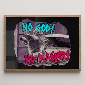 May include: Framed art print with a raccoon illustration, set against a purple and white backdrop. The text "NO GODS NO MASTERS" is written in teal and pink. The artwork has a bold, graphic style.