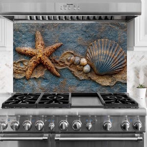 May include: A kitchen backsplash featuring a starfish, seashell, and pebbles on a textured blue and brown background. The design evokes a coastal theme, adding a decorative element to the kitchen.