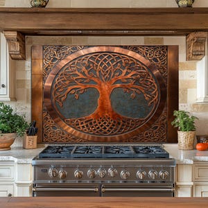 Può includere: Un paraschizzi da cucina in metallo color rame con un design ad albero della vita. L'albero è in una cornice ovale con intricati nodi celtici. Il paraschizzi è sopra un piano cottura a gas in acciaio inossidabile.