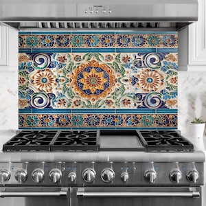 May include: A decorative kitchen backsplash featuring a detailed floral design in blue, yellow, and brown. The backsplash is positioned above a stainless steel gas cooker, providing a colourful accent to the kitchen.