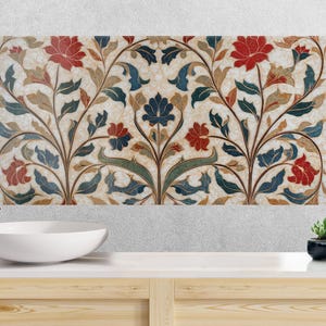 May include: A decorative floral panel with a cream background, featuring red, blue, and green stylized flowers and leaves. The panel has a gold border and is part of a bathroom design, with a white sink and tap.