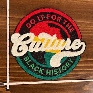 May include: Circular patch with the text "DO IT FOR THE CULTURE BLACK HISTORY". The patch features a red, black, green, yellow, and white color scheme. The word "Culture" is in a large, white, textured font.