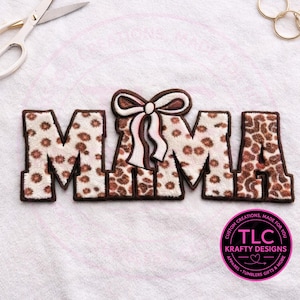 May include: A decorative patch spelling "MAMA" in a bold, block letter style. The letters have a leopard print pattern with brown trim. A bow with brown and white stripes is between the "M" and "A". A circular logo with text is in the bottom right corner.