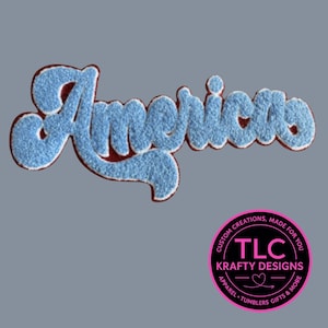 May include: A light blue, textured patch with the word "Americas" in a script font. The patch has a red border and white trim. A circular logo with the text "TLC Krafty Designs" is in the lower right corner.