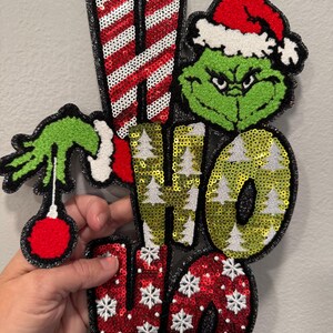Grinchy Ho Ho Ho Christmas Patch – Funny Grinchmas Sequin Applique, Holiday Iron On Patch, Green Santa Hand Holding Ornament