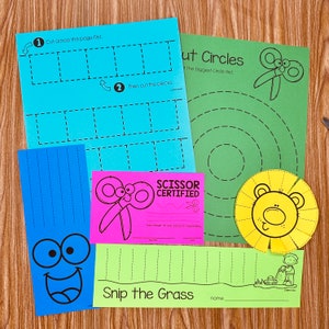 May include: A set of printable scissor skills worksheets for children. The worksheets feature a variety of activities, including cutting out shapes, cutting along lines, and snipping grass. The worksheets are designed to help children develop their fine motor skills and hand-eye coordination.