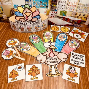 May include: A Thanksgiving-themed educational game for children called "Turkey Trouble" with colourful turkey-shaped pieces, a crown, and sequencing cards. The game includes a turkey with a colourful tail, a crown with a turkey on top, and cards with different images of turkeys and other animals.