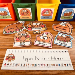 May include: A set of colorful bins with Thanksgiving-themed characters and names, including Ross, Chandler, Monica, Phoebe, and Joey. There are also individual cut-out characters with names, including turkeys, pies, and a table with the words "Type Name Here" and a letter chart.