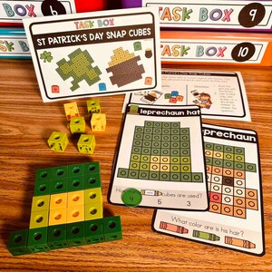 May include: A set of St. Patrick's Day themed snap cube activities for kids. The cards feature a leprechaun hat, a pot of gold, and a shamrock. The cards ask questions about the number of cubes used and the color of the leprechaun's hair.