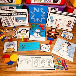 May include: A set of educational activity cards for preschoolers featuring a snowman theme. The cards include a snowman word ladder, a counting snowman buttons activity, a winter punch card, and a snowman body parts activity. The cards are printed on white cardstock with colorful illustrations.