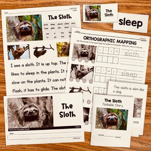 May include: A set of educational materials for children featuring a sloth. The materials include a storybook, an orthographic mapping worksheet, and a decodable reader. The materials are designed to help children learn about sloths and improve their reading skills.