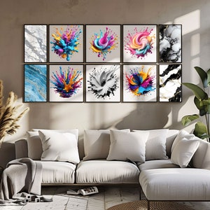 May include: A set of nine framed prints featuring abstract colorful paint splatter designs and marble patterns. The prints are arranged in a grid on a wall above a white couch.