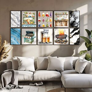 May include: A set of nine framed watercolor prints featuring various kitchen and bar themes. The prints include a marble design, a kitchen with shelves, a collection of bottles, a bar with taps, a grill with flames, and a blue and gold abstract design.