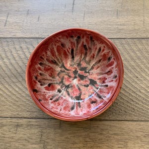 May include: A set of three ceramic mugs with a speckled, matte finish. The mugs are in shades of cream, light gray, and dark gray. Each mug has a simple, minimalist design, perfect for coffee or tea.