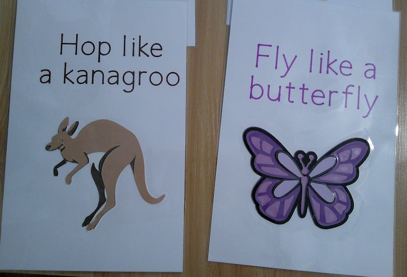 May include: Two white cards with text and illustrations. One says "Hop like a kanagroo" with a brown kangaroo. The other says "Fly like a butterfly" with a purple butterfly.
