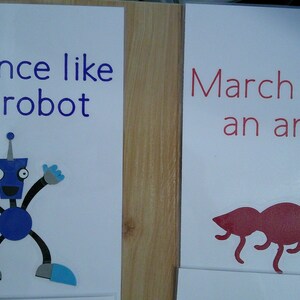 May include: Two educational posters. One says "Dance like a robot" with a blue robot illustration. The other says "March like an ant" with a red ant illustration. Both are on white backgrounds.