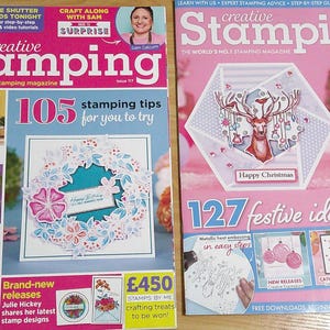May include: Two magazines titled "Creative Stamping" are displayed. The left magazine features a floral wreath design and the text "105 stamping tips". The right magazine has a deer illustration and the text "127 festive ideas to try".