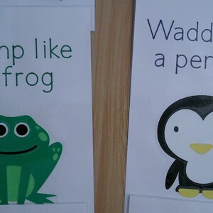 May include: Two educational cards with illustrations and text. One card says "Jump like a frog" with a green frog graphic. The other says "Waddle like a penguin" with a penguin graphic. The text and graphics are in black and green.