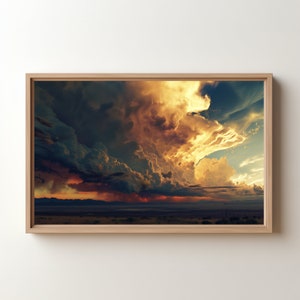 May include: A framed photograph of a dramatic sunset with a large, dark, stormy cloud formation in the sky. The clouds are lit by the setting sun, creating a vibrant orange and yellow glow. The horizon is a dark line against the bright sky.