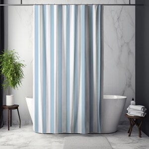 May include: A blue, white, and gray striped shower curtain hangs in front of a white bathtub. The curtain is the focal point, with vertical stripes. A small gray bath mat sits on the floor. A small wooden table holds a stack of white towels.