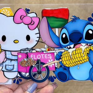 May include: A colorful illustration featuring Hello Kitty and Stitch enjoying corn on the cob. Hello Kitty is next to a pink elotes cart. Jarritos soda bottles and Mexican flags are also included in the design.