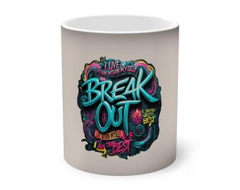 May include: A beige ceramic mug with a colorful graphic design featuring the words "Break Out" in a blue and pink font. The design also includes the text "I live within myself, I dream with the best, I am the best".