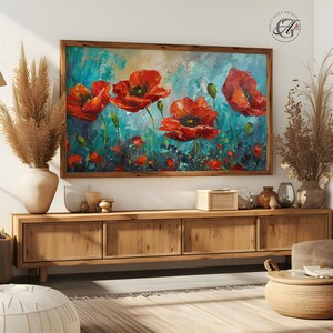 Puede incluir: Una pintura enmarcada de amapolas rojas sobre un fondo azul y verde. La pintura está colgada en una pared sobre un armario de madera.
