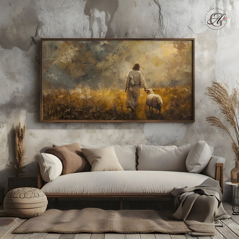 May include: A painting of a man in a white robe walking through a field with a sheep. The sky is cloudy and the field is green and brown. The painting is framed in a brown wood frame.