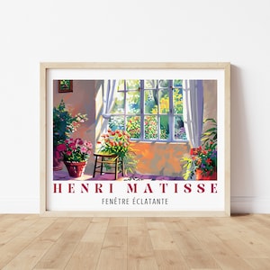 May include: A framed print of a painting by Henri Matisse titled "Fenêtre Éclatante". The painting depicts a room with a window overlooking a garden. The window is open and sunlight streams in, illuminating the room. There are potted plants in the room, including a large one in the corner.