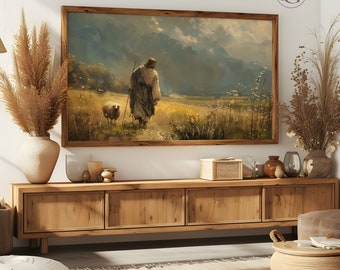 May include: A framed painting depicting a man walking with a sheep in a field. The man is wearing a long robe and the sheep is white. The background is a landscape with mountains and clouds.