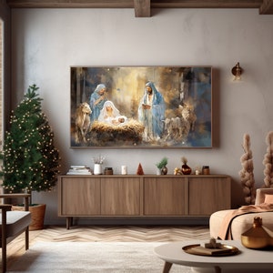 May include: A watercolour painting depicting the nativity scene with Mary, Joseph, and baby Jesus in a stable with animals. The painting is framed and hanging on a wall in a living room setting.