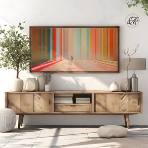 May include: A modern abstract art print with a colorful striped pattern in shades of red, orange, yellow, green, blue, and pink. The print features a single figure walking towards a light source in the distance.